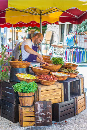 SAINT-SATURNIN-LES-APT, FRANCE - AUGUST 11, 2015: Cook on village street market preparing Provansal sauces. Village is situated at the dominant position on the Monts de Vaucluse facing south towards the Luberon. It has around 3000 inhabitants.のeditorial素材