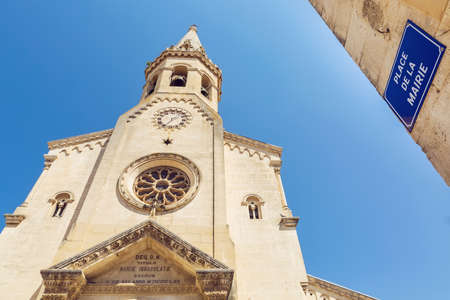 View on St. Etienne church tower at Place de la Mairie in Saint-Saturnin-les-Apt, France.の写真素材