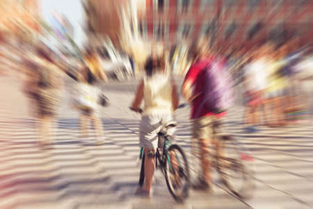 Back view of two blurred tourist cyclists - husband and wife, seniors -  on street in city in Nice, France.の写真素材