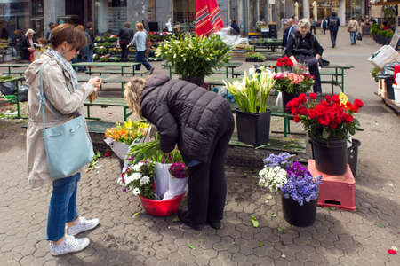 ZAGREB, CROATIA - APRIL 25, 2017: Female customer buying flowers on the street market flower shop in Zagreb City center. Zagreb is capital of Croatia and its largest city.のeditorial素材