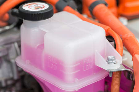 Pink cooling fluid in a plastic container - engine of a hybrid car powered both by electric battery and gasの写真素材