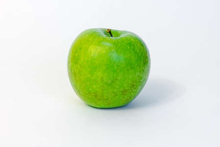 Green,  tasty apple, isolated on white backgroundの写真素材