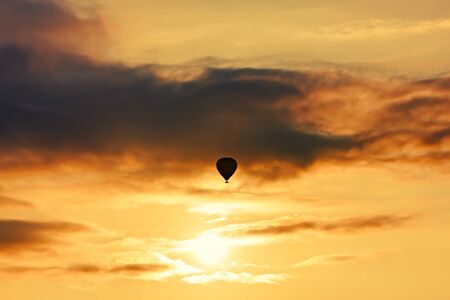 Balloon silhouette with sunrise in the skyの写真素材