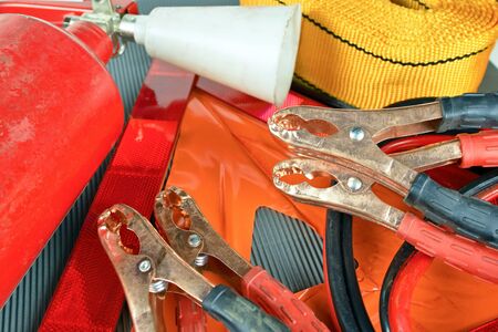 Elements of the essentials for a passenger car. Danger Safety Warning Triangle Sign, towing rope,...