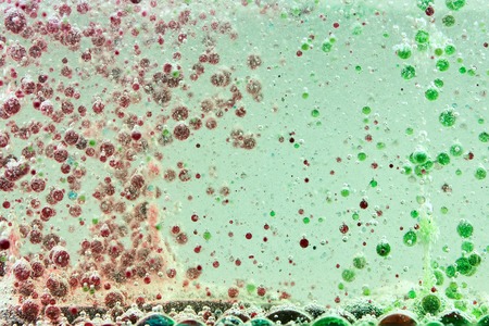 Bright and colorful multi-colored liquid in motion. Lava lamp with green, yellow, blue, purple...