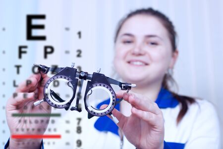 Close-up of optometrist holding messbrille glasses in ophthalmology clinic. Ophthalmic glasses for diopter detection.の写真素材
