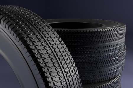New winter tires with a modern tread on the black background. 3d high resolution image.の写真素材