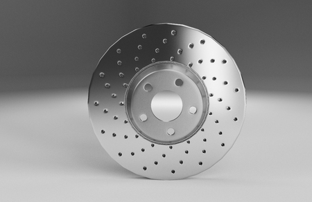 Auto spare parts for passenger car, new brake disk on white backgroundの写真素材