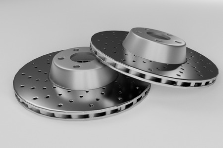 Auto spare parts for passenger car, new brake disk on white backgroundの写真素材
