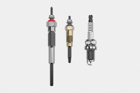 Two types of auto parts glow plug and spark plug on a white background. Spare part for the car...