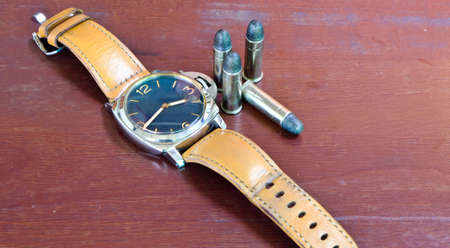 Watches and shells placed on a wooden table brown