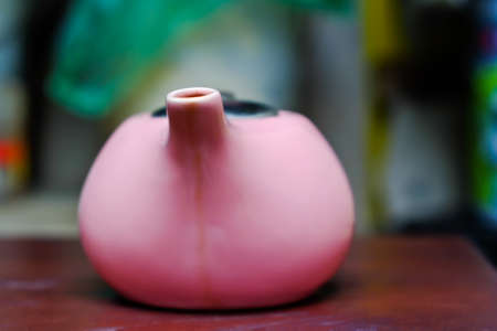 Pink ceramic pot on a wooden table brown.の写真素材