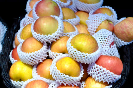 Closeup shot of fresh red and yellow apples (apple)の写真素材