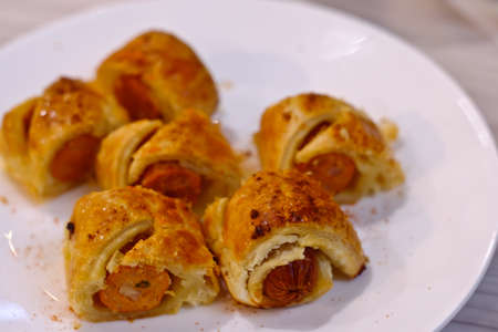 Sausage rolls on a white plate.の写真素材