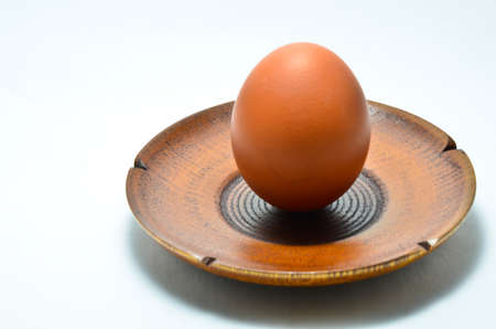 eggs in a wood plate placed on a white background.の写真素材