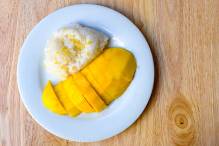 Sticky rice in coconut cream with ripe mangoの写真素材