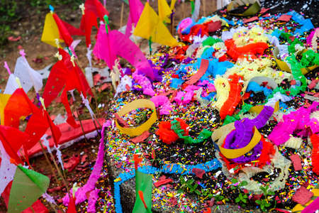 Wind with Colored papers placed on a grave during Qingming Festival at Songkhla Thailand.