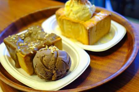 Honey toast with ice cream on white plateの写真素材