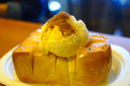 Honey toast with ice cream on white plate