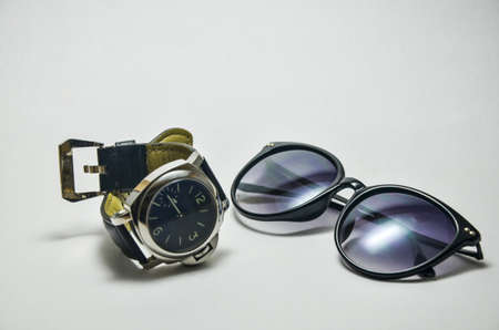 Black sunglasses and watches Isolated on white background