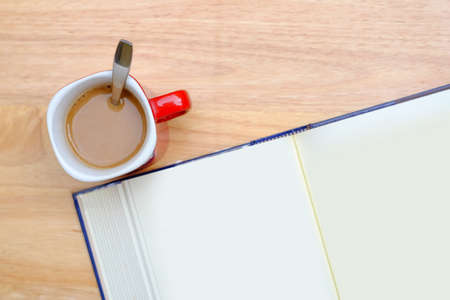 Coffee and books on a wooden table brown.. (During the warm sunshine)の写真素材