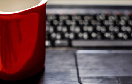 Desk table with laptop, coffee cup,  on wooden table. Workplaceの写真素材