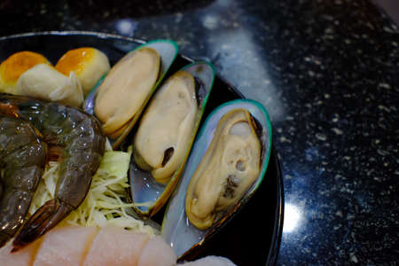 Shellfish plate of crustacean seafood as fresh lobster steamed clams mussels shrimp and crab as an ocean gourmet dinner background.の写真素材