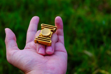 fidget spinner on hand with love. (Brass fidget spinner)
