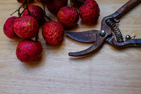 fresh lychees on wood table (lychee, litchi, fruit)の写真素材