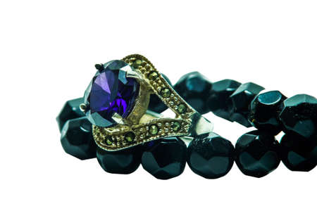 Sapphire ring with onyx bead necklace on white backgroundの写真素材