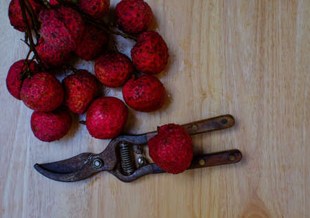 fresh lychees on wood table (lychee, litchi, fruit)の写真素材