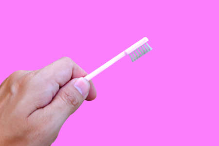 Thumbs Up with Pink Toothbrush on natureの写真素材