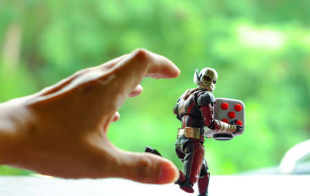 Songkhla, Thailand - July 19, 2017: ant man Fidget Cube running away from the man's hand.のeditorial素材