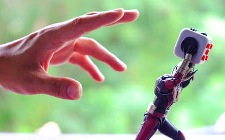 Songkhla, Thailand - July 19, 2017: ant man playing Fidget Cube stress reliever, Fingers Toy (Relax)のeditorial素材