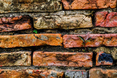 Old brick wall, old texture of red stone blocks closeup