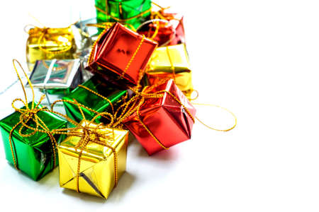 green, red, silver and gold gift box with a ribbon and a bow isolated.
