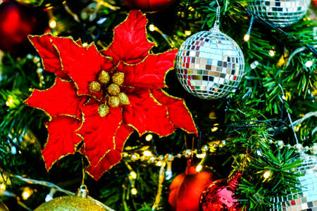 Merry Christmas and Happy New Year, Closeup of white bauble hanging from a decorated tree with bokeh, Xmas holiday background.の写真素材