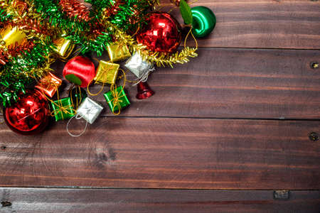 Old vintage Christmas decoration background arranged in opposing corners on rustic wood with copyspaceの写真素材