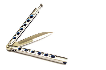 Butterfly knife (balisong) in a folded state against a light backgroundの写真素材