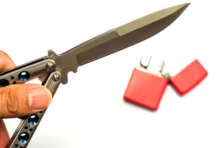 Butterfly knife (balisong) in female hand on a white backgroundの写真素材