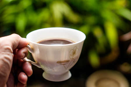 black hot coffee on nature background, hot coffee and smoke