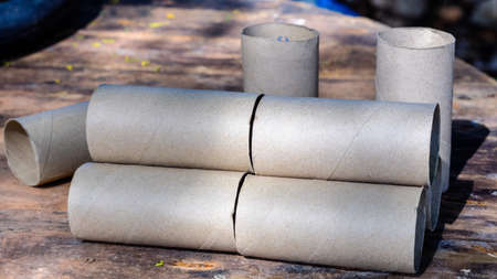 empty tissue paper roll on wood background (clipping path)の写真素材