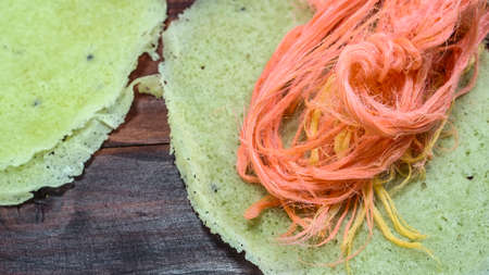 Thai cotton candy burrito pancake on wood backgroundの写真素材