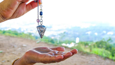 holding and using quartz crystal pendulum and using it In asking questions. Quartz Crystal Pendulum...