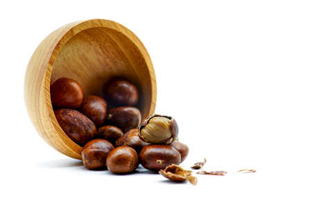 Ripe chestnuts on bowl wooden on white background. close up with copy space. Roasted Chestnuts