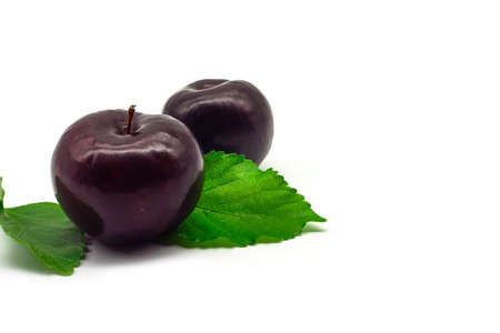 cherry plum with green leaves isolated on white background