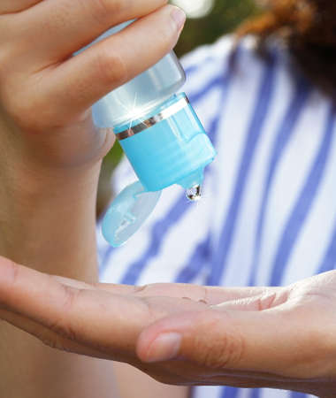 Women's hands using wash hand sanitizer gel pump dispenser. copy space in anti virus and epidemic preventive concept.の写真素材