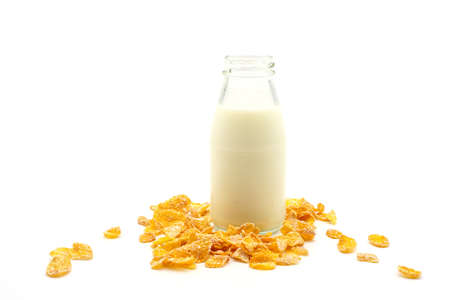 Cornflakes cereal and milk in glass bottles isolated on white background.