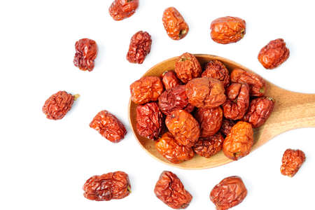 dried unabi fruit or jujube in wood spoon of on white background. copy space for text.の写真素材