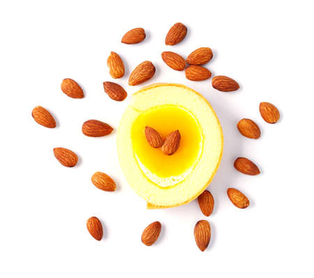 creamy mango mousse cake  topping almonds isolated on a white background. top view.  pathsの写真素材